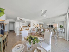 A modern interior with a dining area, kitchen, and living space. - Destin Pointe Magnolia House #306 | Luxe Condo, Beautiful Views + Amenities (Destin)