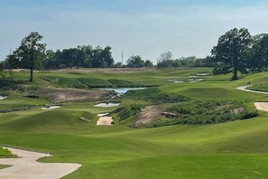 A golf course with sand bunkers, water hazards, and trees. - Grand Lake Golf Getaway Near Shangri-la, Game Room (Afton)