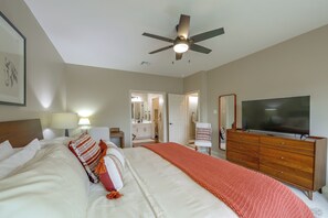 A hotel room with a bed, a dresser, a television, and a ceiling fan. - Walk to Texas A&m! Quiet Home w/ Fenced Yard (College Station)