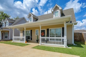 A two-story house with a covered porch, a front door with a cross, and a mailbox. - Walk to Texas A&m! Quiet Home w/ Fenced Yard (College Station)