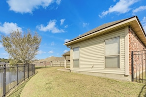 A residential property with a fenced yard, a detached garage, and a brick wall.