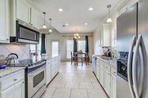 A modern kitchen with a built-in microwave, stove, and refrigerator.
