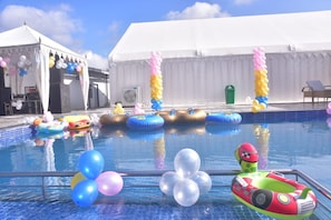 A swimming pool with inflatable toys and balloons, surrounded by a white tent structure. - EcoTown Resort (Jaipur)