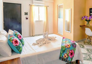 A hotel room with a bed, a desk, and a chair. - Memory Foam King Bed - Easy Mornings. 5th Ave, ADO, Cozumel Ferry & Beach 4 Mins (Playa del Carmen)
