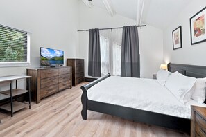 A bedroom with a bed, a desk, a dresser, and a television. - Spacious Vail Condo, steps to Free Shuttle | BW534 (Vail)