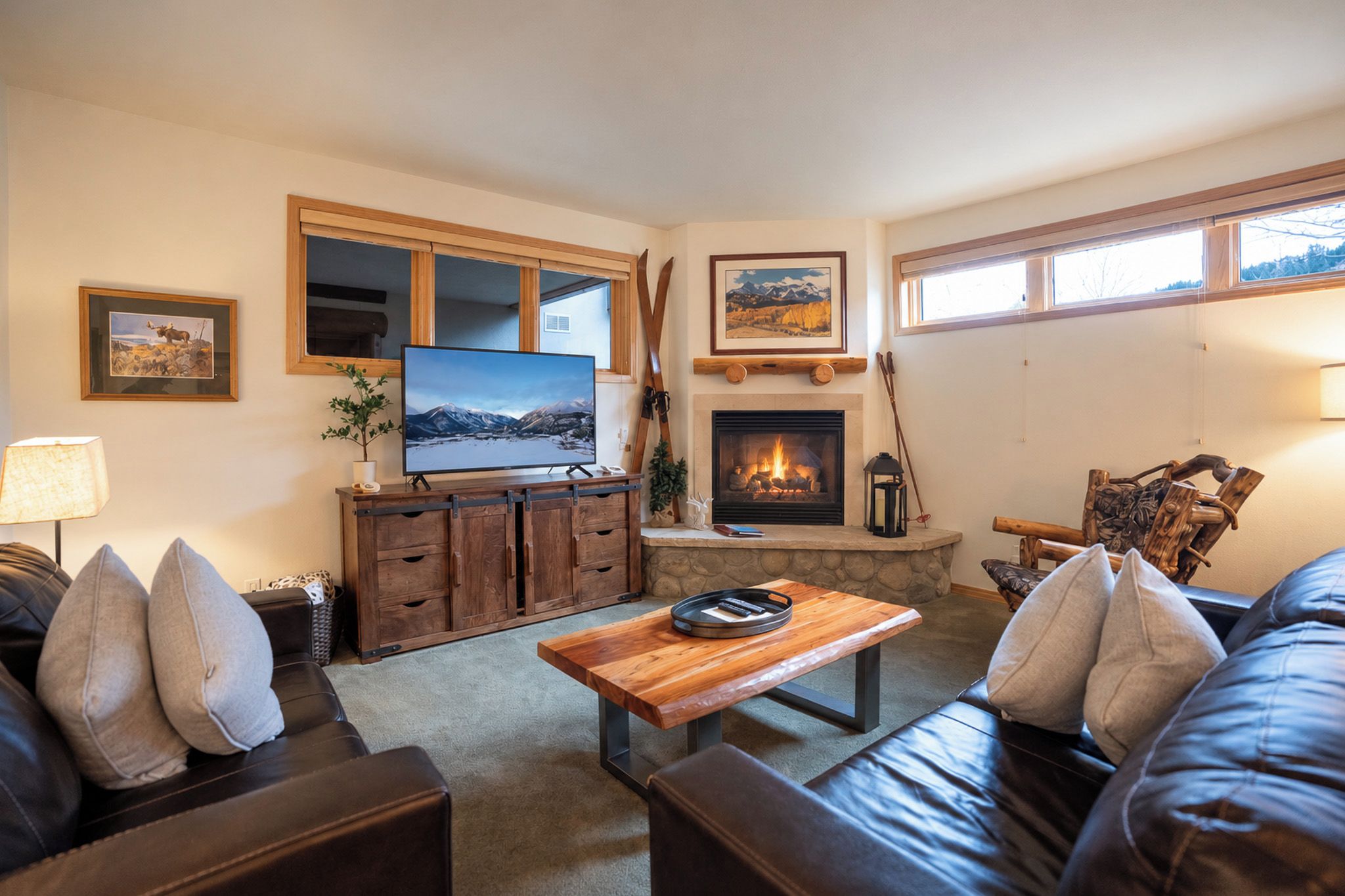 A cozy living room with a fireplace, a television, and comfortable seating.