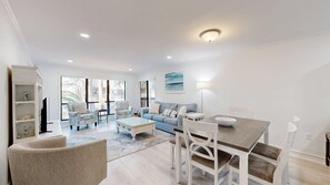 A spacious living area with a sofa, coffee table, and dining table. - 89 The Moorings: 2  BR, 3  BA Villa in Hilton Head, Sleeps 6 (Hilton Head)
