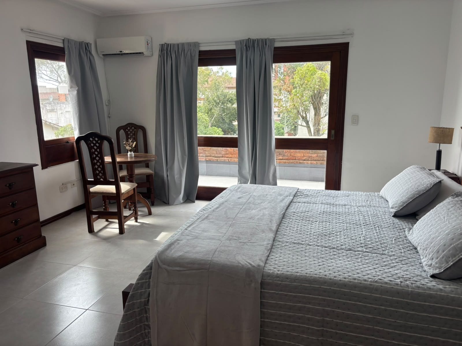 Une chambre à coucher avec un lit, un bureau, une chaise et une commode.