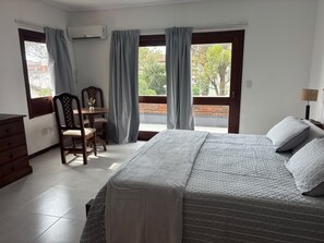 A bedroom with a bed, a desk, a chair, and a dresser. - Bakumare Hotel (Pinamar)
