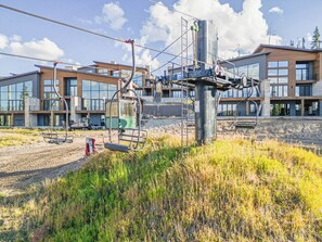A modern building with large windows and a construction site in the foreground. - Ski-In/Out Luxury | Private Hot Tub + Sauna (Brian Head)