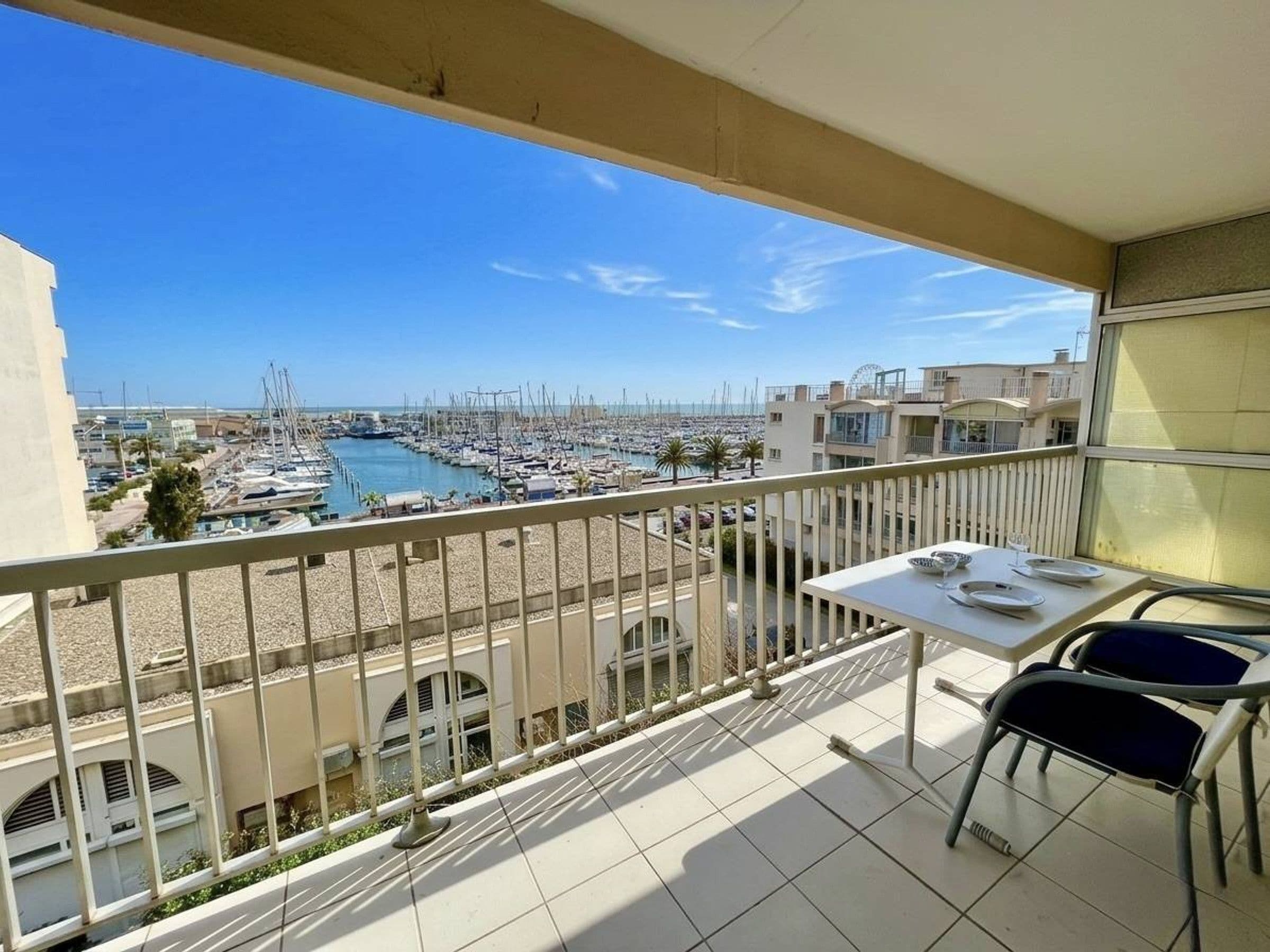 A balcony with a view of a marina and buildings.