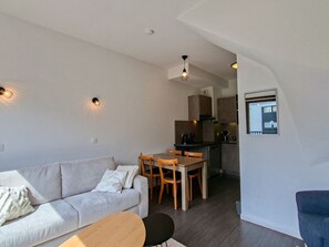 A compact living space with a sofa, dining table, chairs, a kitchenette, and a small kitchen area. - Apartment at the slopes, parking - 6 guests (Flaine)
