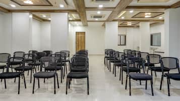 A conference room with rows of chairs, a wooden door, and a window.