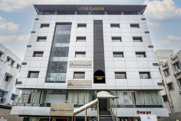 A multi-story building with a prominent sign for Lotus Garden at the top.