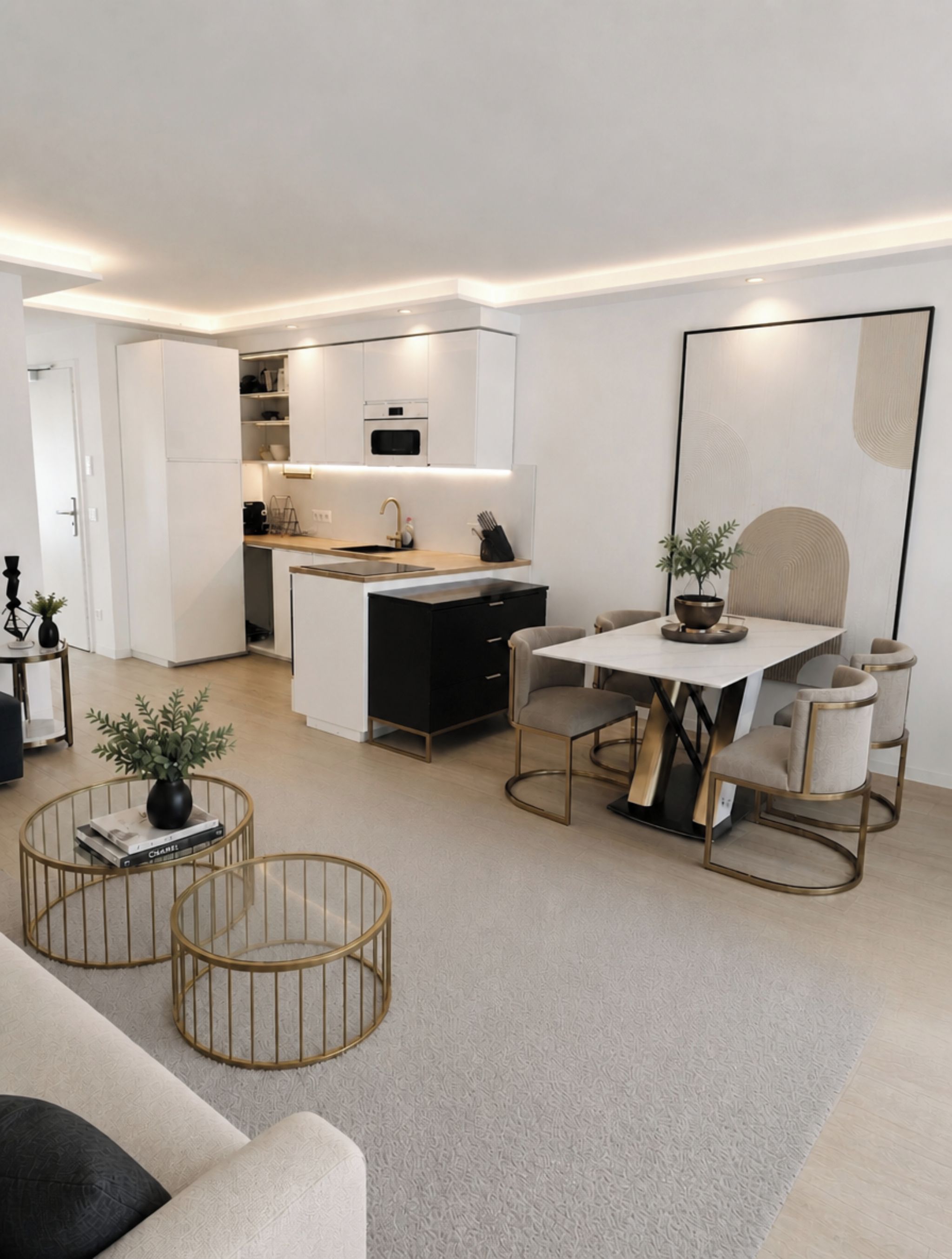 A modern, compact living space with a kitchenette, a dining area with a table and chairs, and a seating area with a sofa and coffee table.