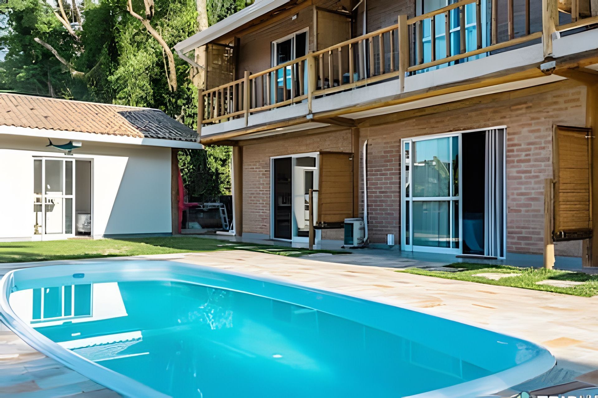 A two-story house with a swimming pool, a balcony, and a garage.
