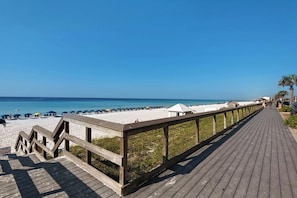 A wooden boardwalk leading to a beach with umbrellas and a small structure. - ✨ Walk 2 Beach-Gulf Views-Indoor/Outdoor Pool-Majestic Sun 303B ✨ (Miramar Beach)