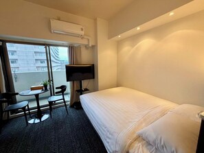 A hotel room with a bed, a TV, a small table with chairs, and a window with a view of buildings. - AKATSUKI Nipponbashi (Osaka city,naniwa,nipponbashihigashi)