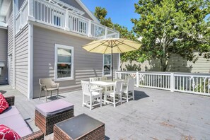 A covered patio with outdoor furniture, a white railing, and a tree. - 🚲Sugar Sand Bungalow | Pet Friendly | Bikes | Spacious Balcony | Walk to Beach🐾 (Santa Rosa Beach)