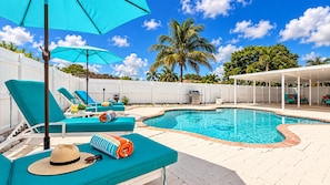 A pool area with lounge chairs, a covered seating area, and a white fence. - Private Pool | BBQ | Outdoor Dining (Hollywood)