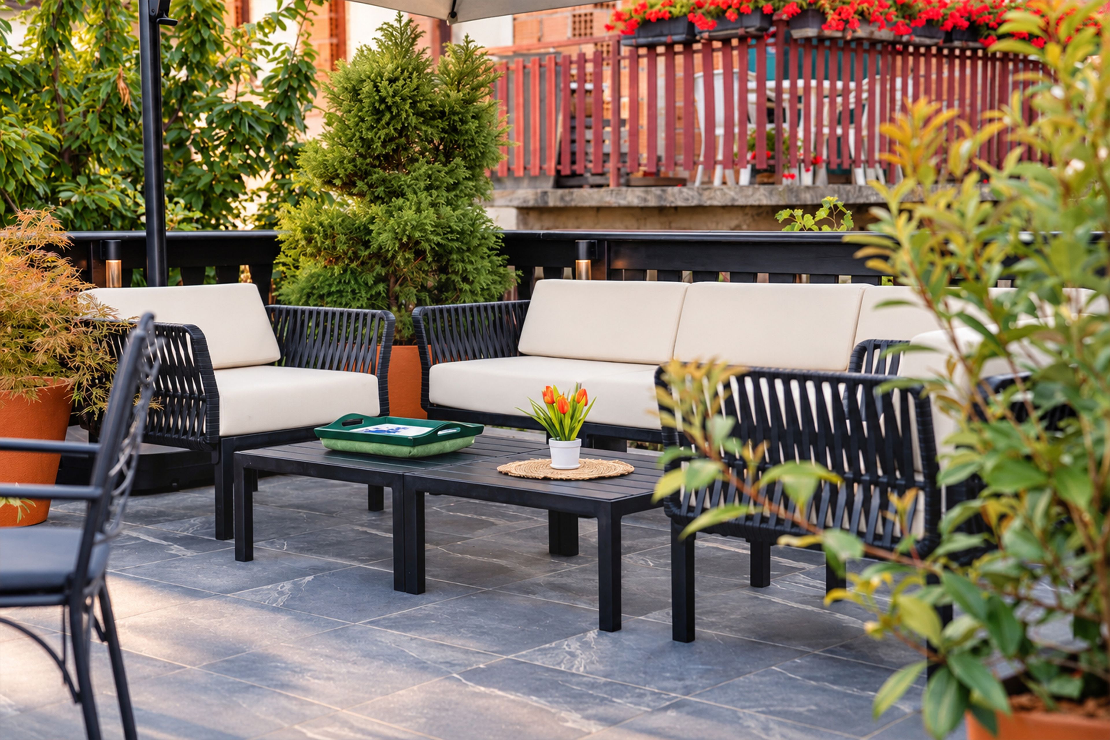 An outdoor seating area with a sofa, chairs, and a table.