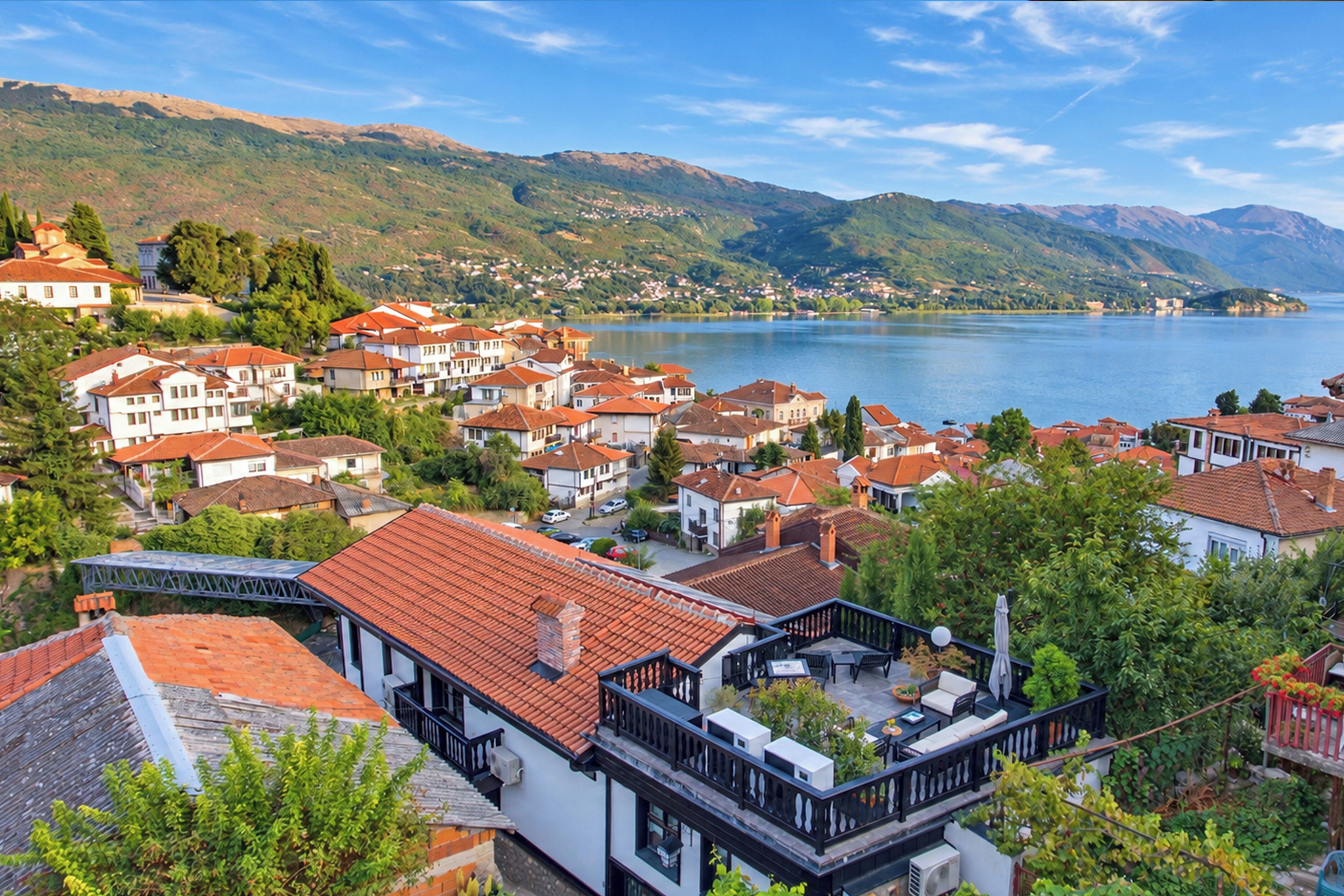A coastal town with terraced houses, a bridge, and a lake.