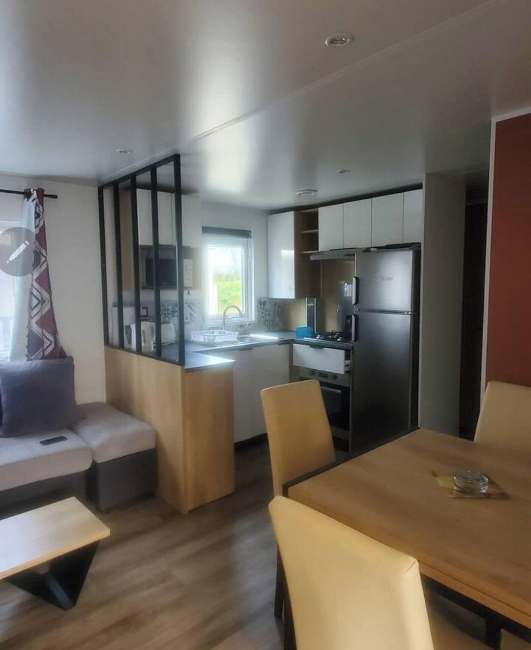 A compact living space with a kitchenette, a dining area, and a seating area.