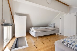 Cozy loft sleeping nook with wood floors and bright natural light