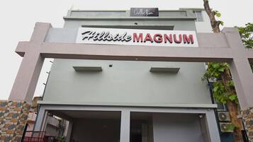A building with a sign that reads 'Hillside MAGNUM.'
