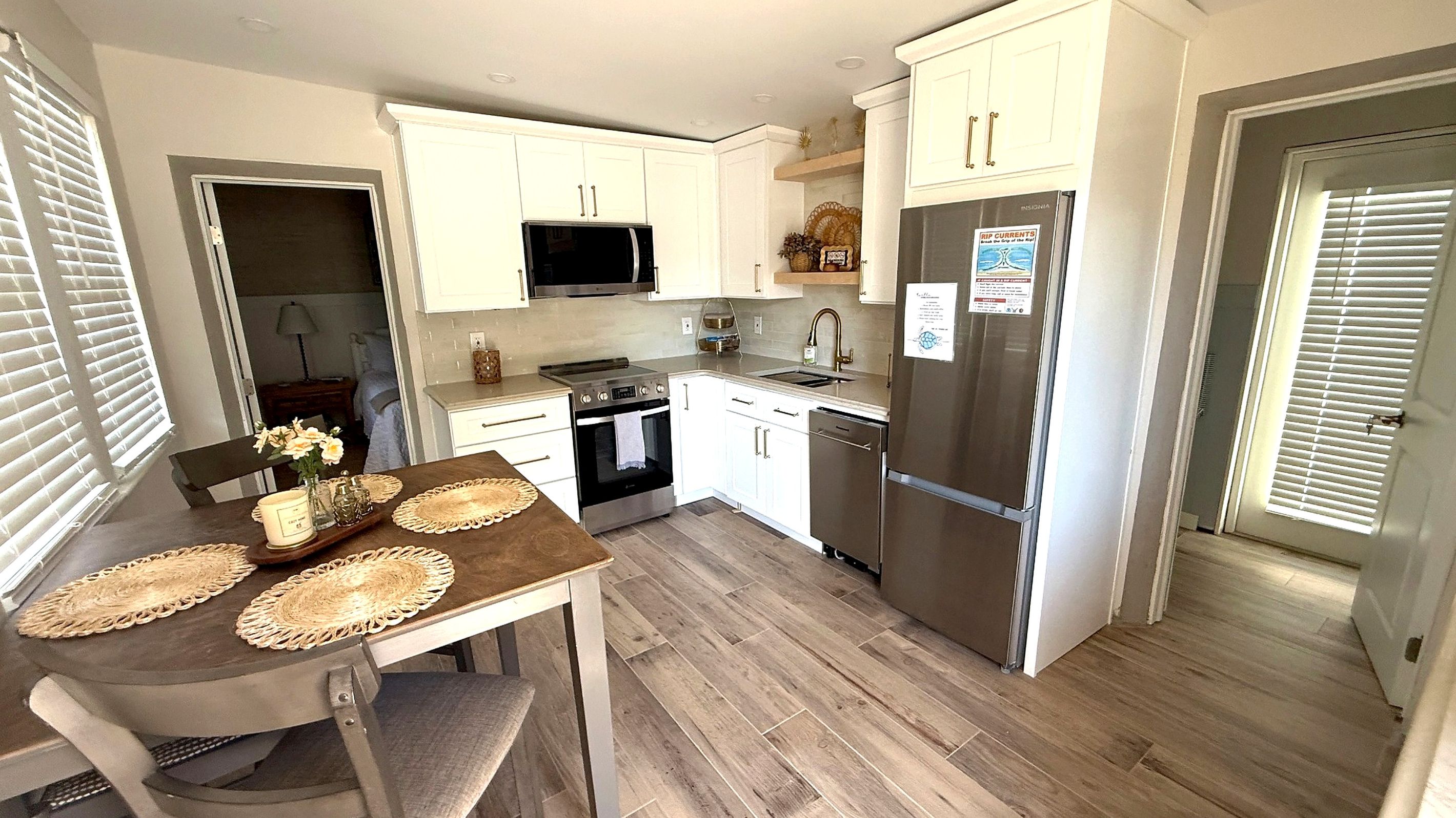 Open kitchen and dining area with a full-size refrigerator and a dining table for relaxed meals.