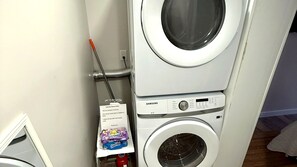 Private laundry room with a stacked washer and dryer. - Private 1BR Garden Cottage | 1 Mi to Madeira Beach (St. Petersburg)