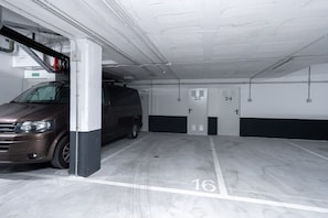 A parking garage with numbered parking spaces, including space 16. - Sea Blue Torrox Costa by Casasol (Torrox)