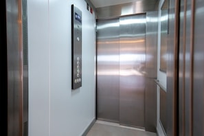 A modern elevator with a control panel and metallic walls. - Sea Blue Torrox Costa by Casasol (Torrox)