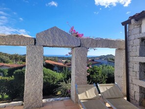 A stone structure with a view of a coastal landscape. - Li Conchi Villa 17 - detached villa within the Li Conchi Village (Castiadas)