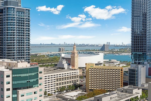 A high-rise building with a modern design, a prominent tower, and a waterfront view. - The Metro Miami Retreat, Parking & Amenities (Miami)
