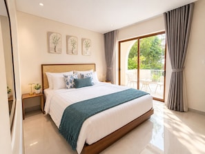 A modern bedroom with a large bed, a wooden headboard, a balcony with curtains, and a wall-mounted plant. - Beachfront Villa Gành Dầu 5Brs by Anamoi (Phú Quốc)