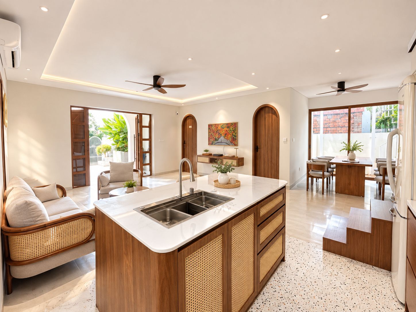 A modern kitchen with a central island, built-in appliances, and a dining area with a table and chairs.