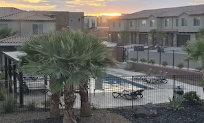 A residential area with houses, a swimming pool, and a fenced patio area. - TRAILHEAD HIDEAWAY ... A LOVELY 3-BEDROOM TOWNHOME IN WASHINGTON, UTAH (Washington)