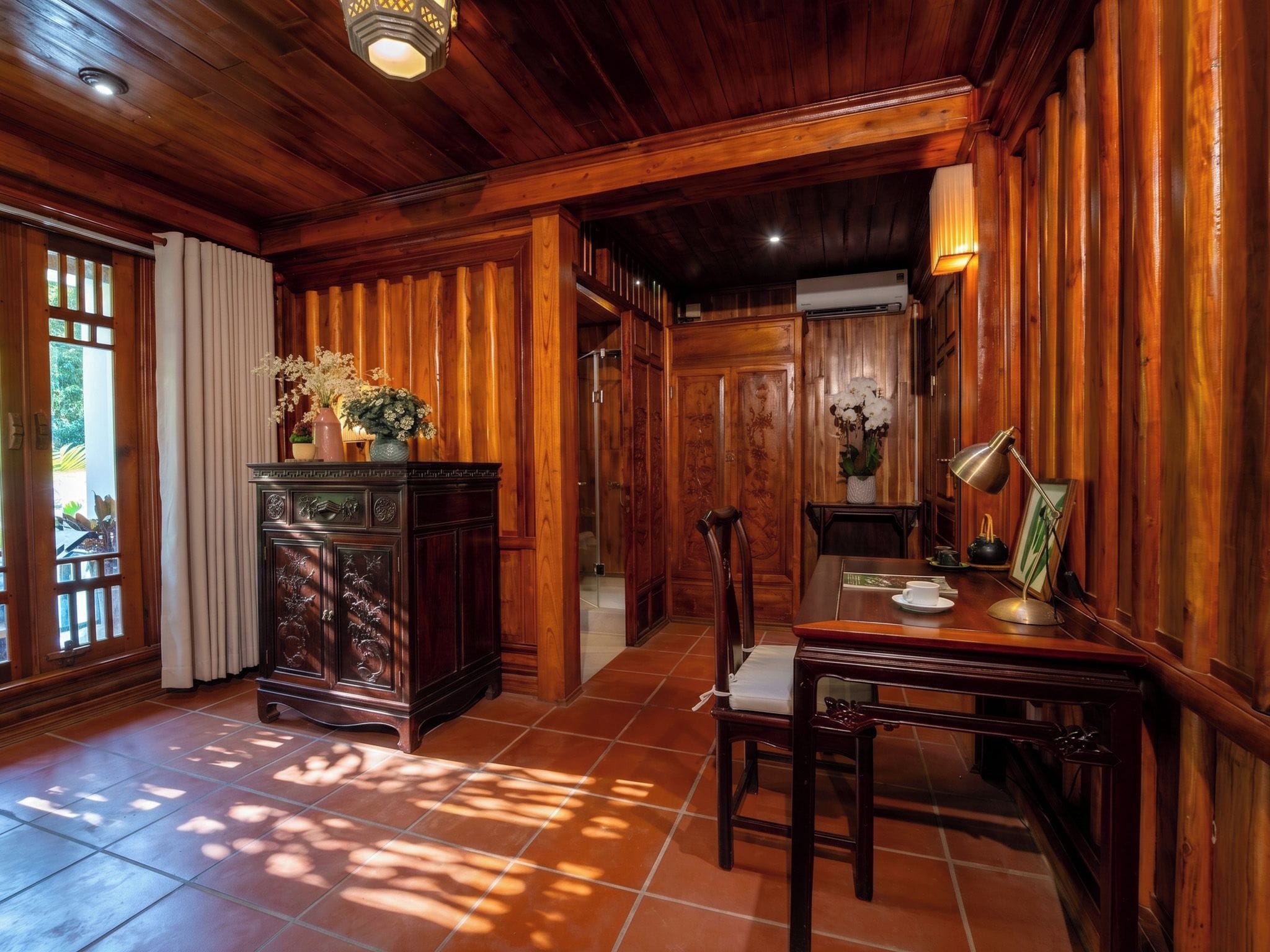 A wooden-paneled room with a dining table, chairs, and a cabinet with decorative items.