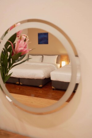 A bedroom with a bed, pillows, a bedside table, and a wall-mounted picture. - Central Old Quarter: City View Balcony, Walk to Night Market (Hà Nội)