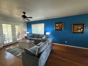 A living room with a sectional sofa, a coffee table, a ceiling fan, and artwork on the walls. - 6 Bell Rock Villas Condo W/Red Rock View + Hot Tub (Sedona)