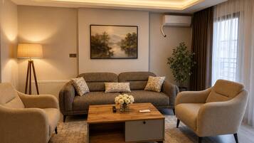 A living room with a sofa set, a coffee table, a lamp, and a painting on the wall.