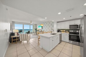 A modern kitchen with a central island, white cabinetry, and stainless steel appliances. - Heated Pool| Steps 2 Beach| King + Bunks| Kid Gear (Destin)