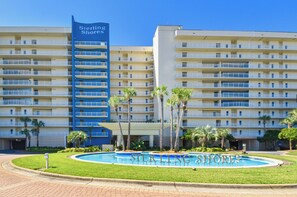 A multi-story hotel with a prominent blue sign reading 'Sterling Shores.' - Heated Pool| Steps 2 Beach| King + Bunks| Kid Gear (Destin)