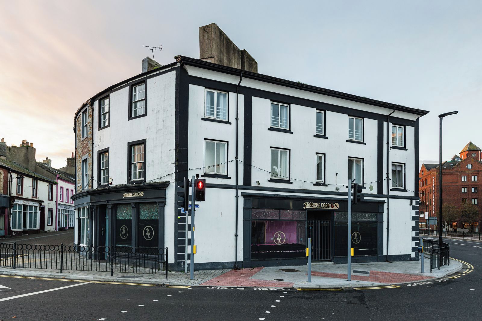 A corner building with a sign for 'Harrogate Corner' and a visible entrance.