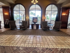 A lobby with a tiled floor, large arched windows, and seating areas. - Sheraton Vistana Villages Spacious 1 BR Premium Villa Orlando Fl. (Orlando)