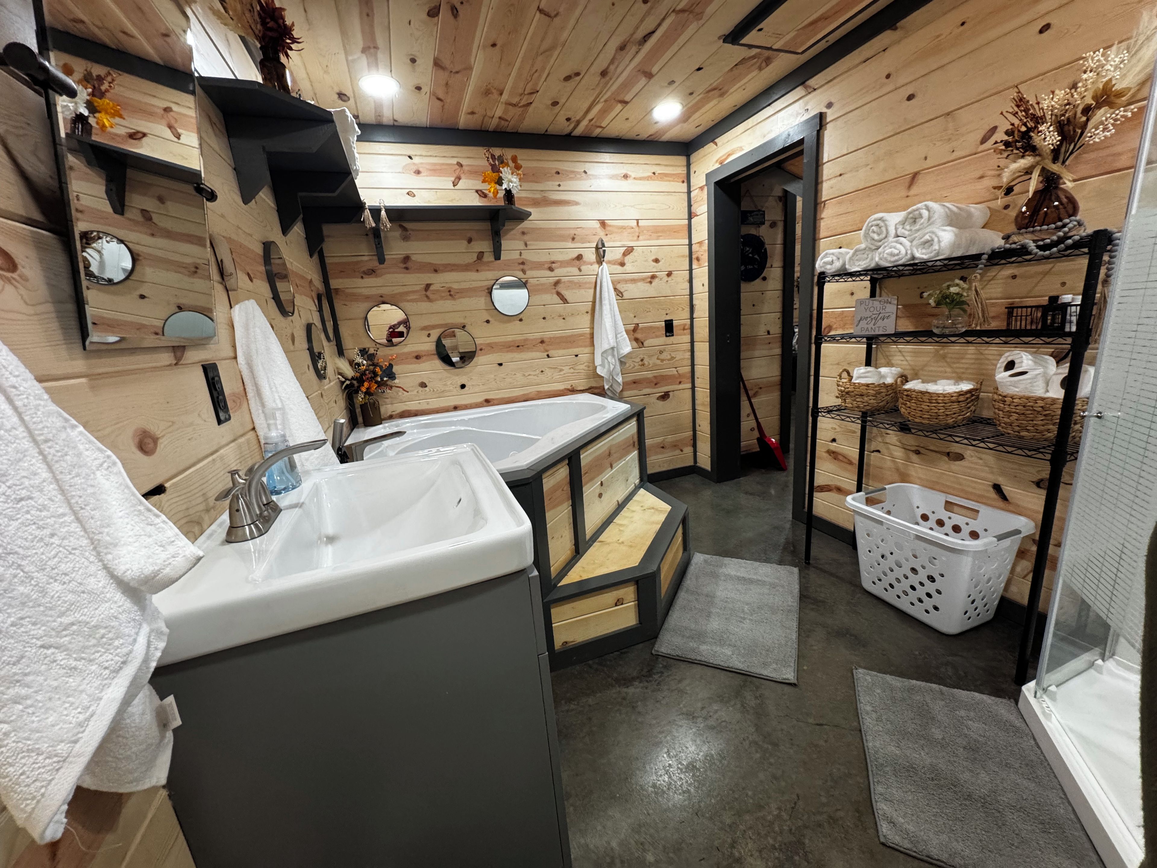 A wooden interior with two sinks, towels, and baskets.
