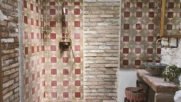Une petite salle de bain comprenant une douche, des toilettes et un lavabo.