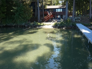 A lake with a wooden dock extending into the water. - Barefoot Shores at Torch Lake (Rapid City)