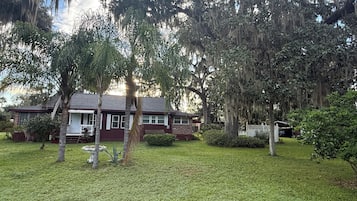Ein Wohnhaus mit Vorgarten, Veranda und Garage.